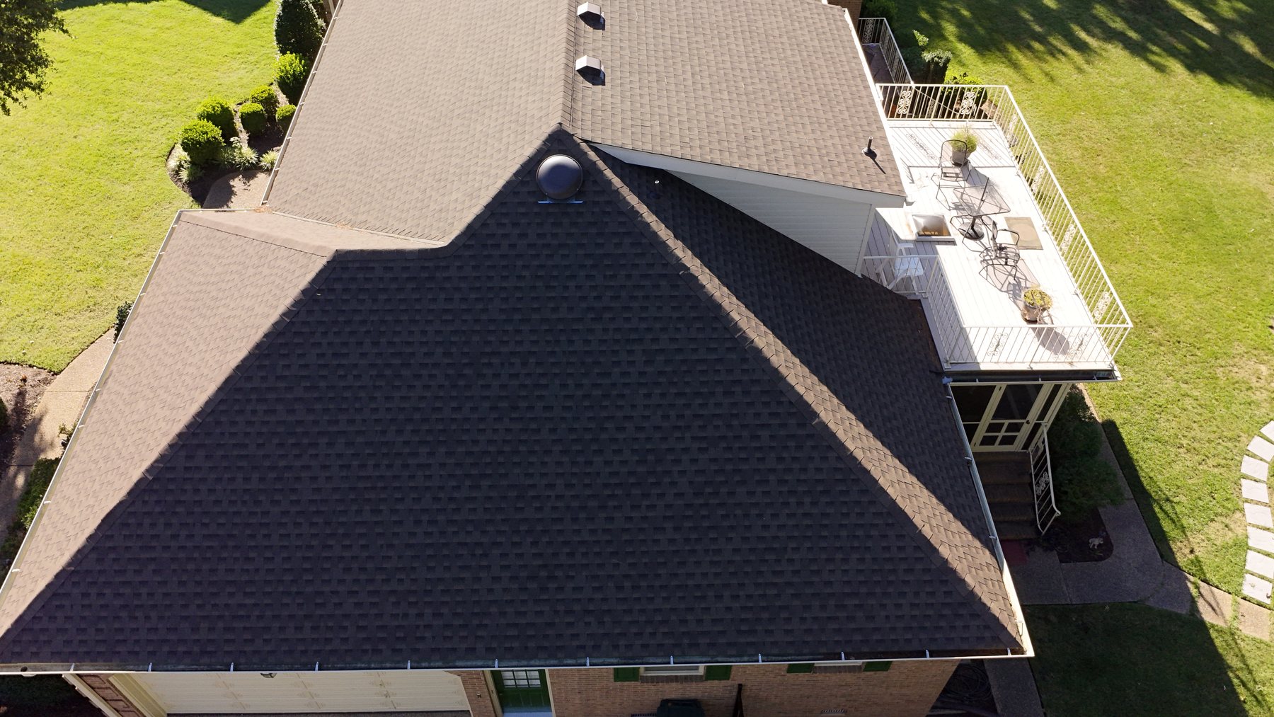 Close aerial view of visible residential roof surfaces